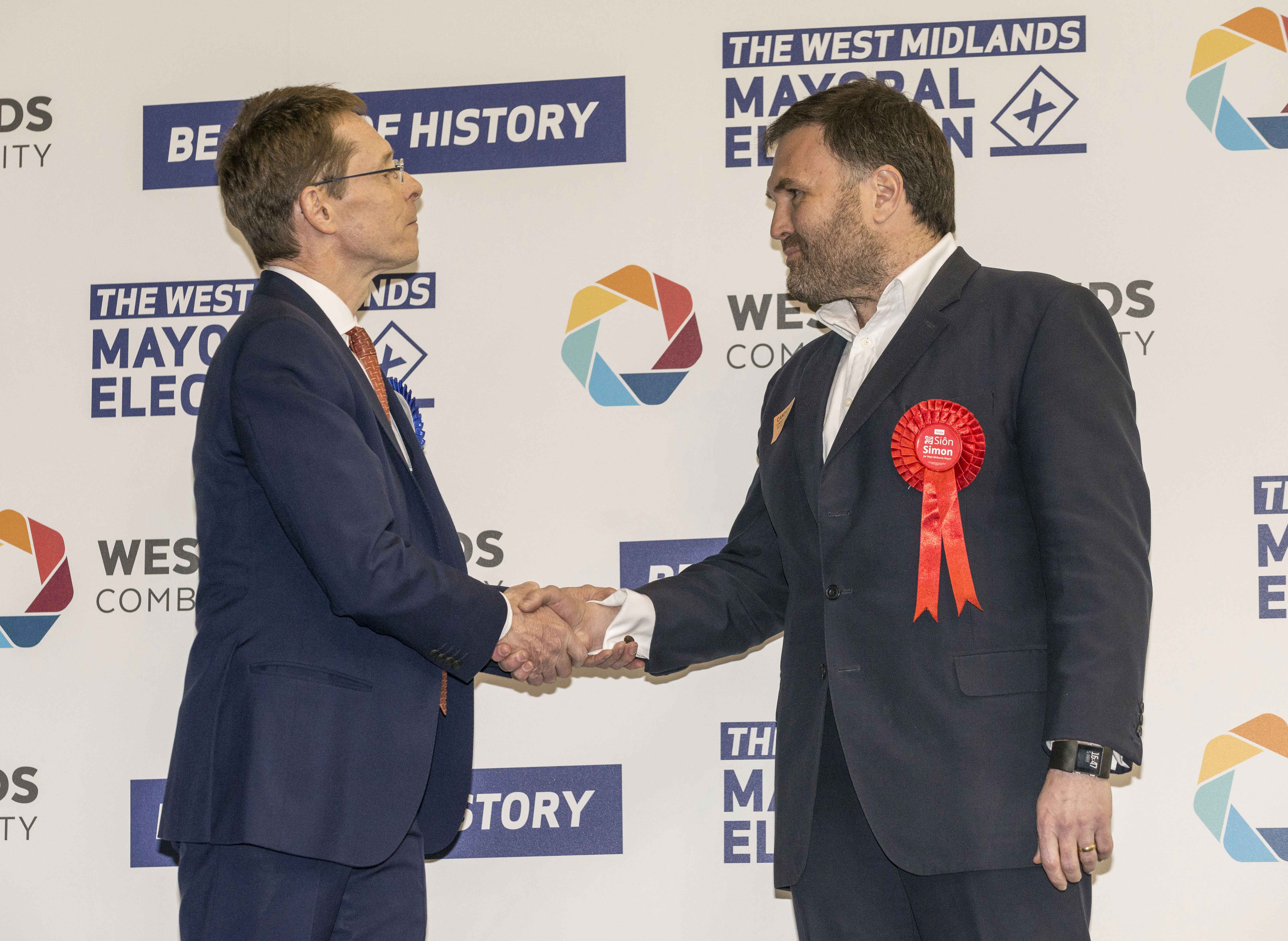 Andy Street, left, shakes hands with Sion Simon following the announcement of the result.