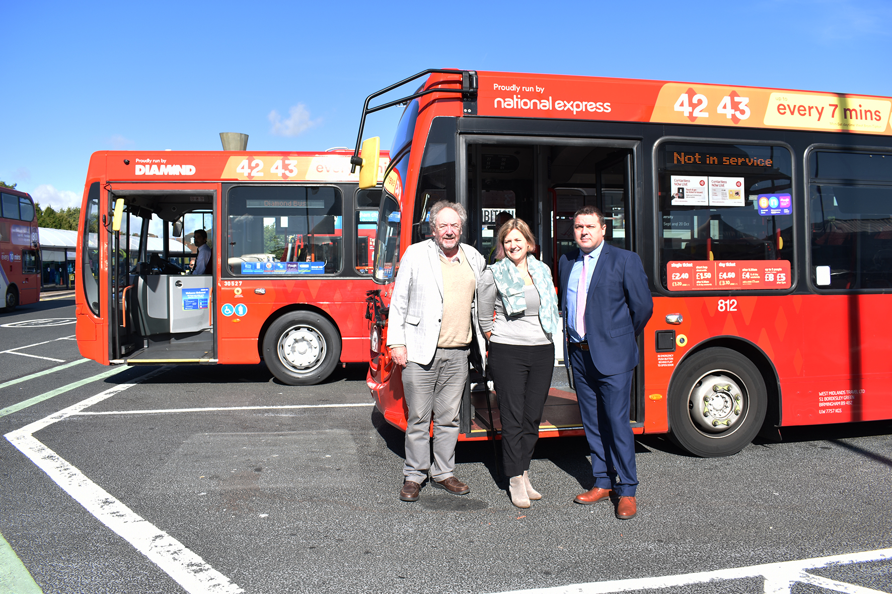 Cllr Roger Lawrence, WMCA portfolio holder for transport, left, Ali Bell, head of external communications (UK Bus) for National Express, and business director Bob Baker from Diamond Bus with the new West Midlands Transport branded buses at West Bromwich bus station
