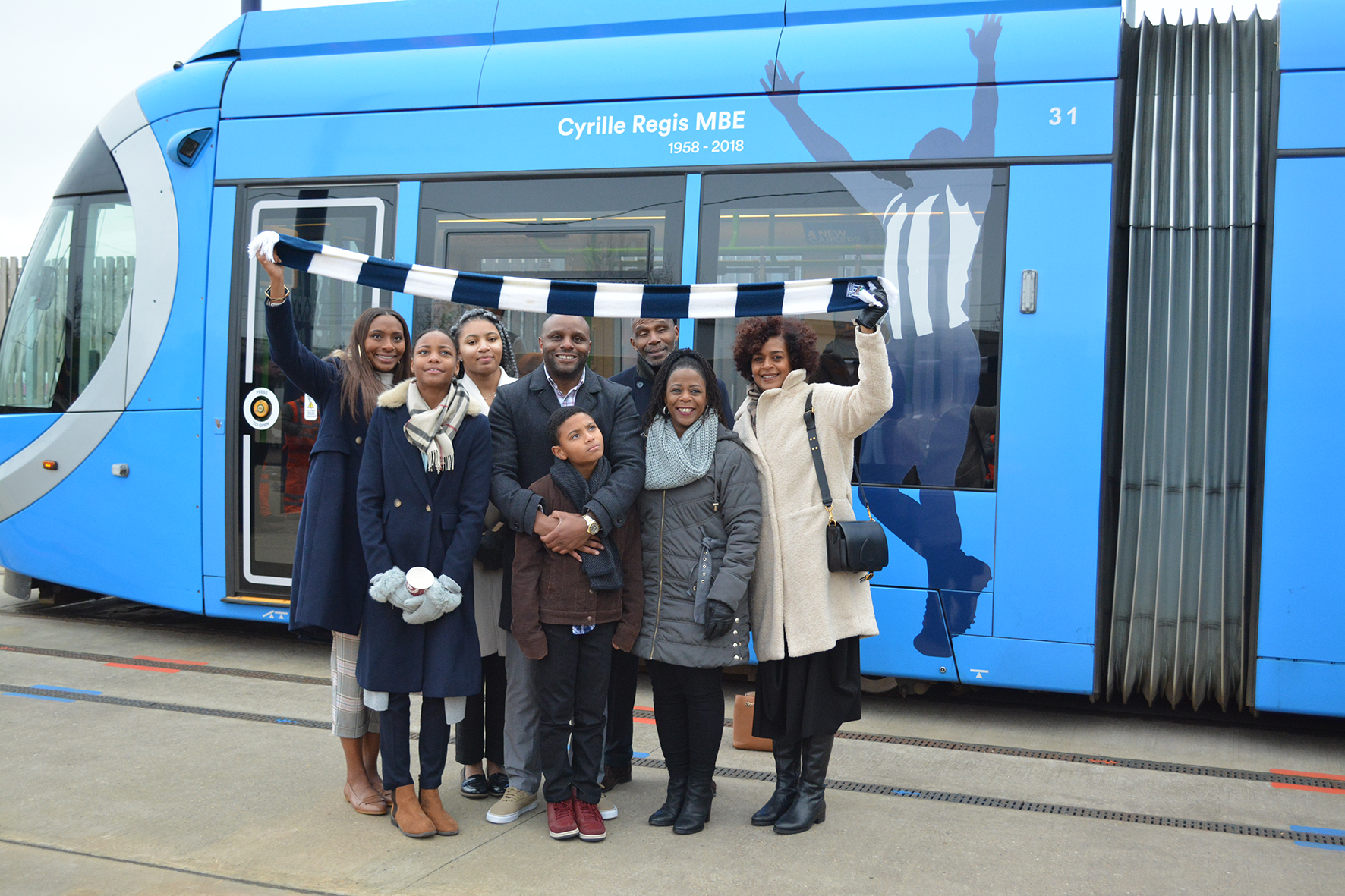 The Regis family with the tram: L-R daughter Michelle, granddaughters Renee and Jayda, son Robert and grandson Riley, brother David, sister Denise and wife Julia
