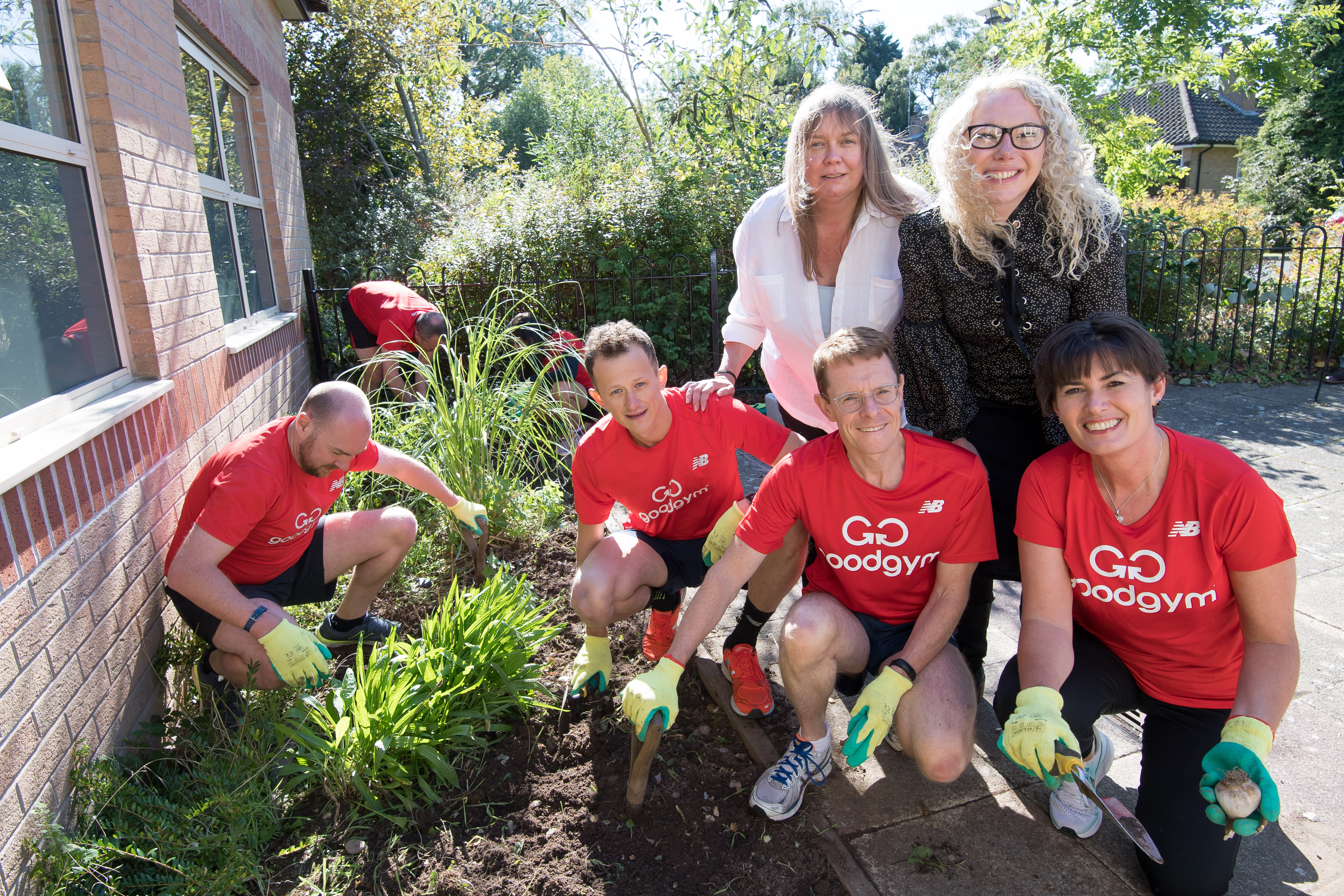 Mayor Andy Street (third from left, bottom row), gets stuck into a community gardening project with runners from GoodGym Solihull.