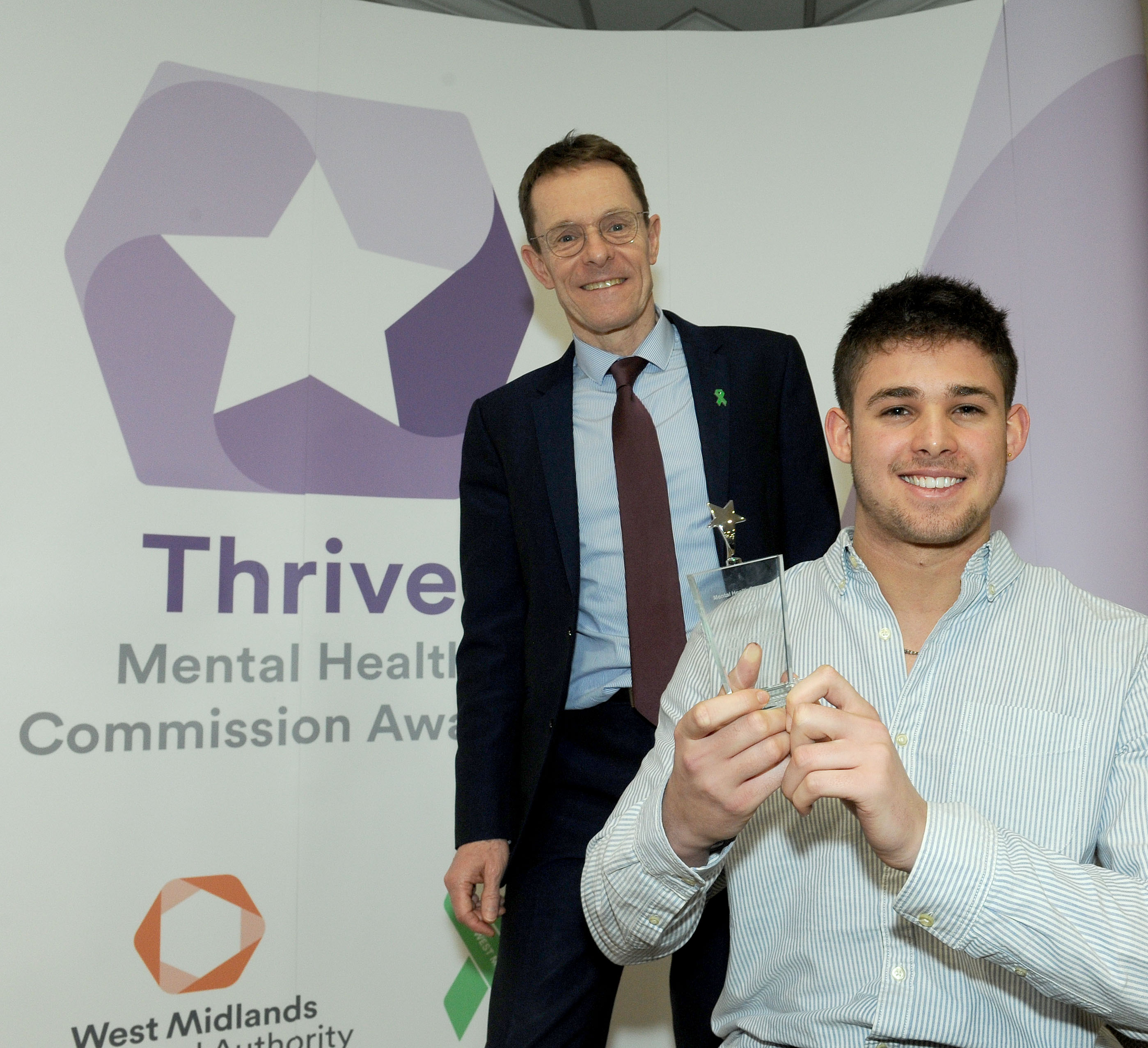 Caleb Turner receives his trophy from Mayor of the West Midlands Andy Street after being named Mental Health Superstar at the Thrive Mental Health Commission Awards 2019.