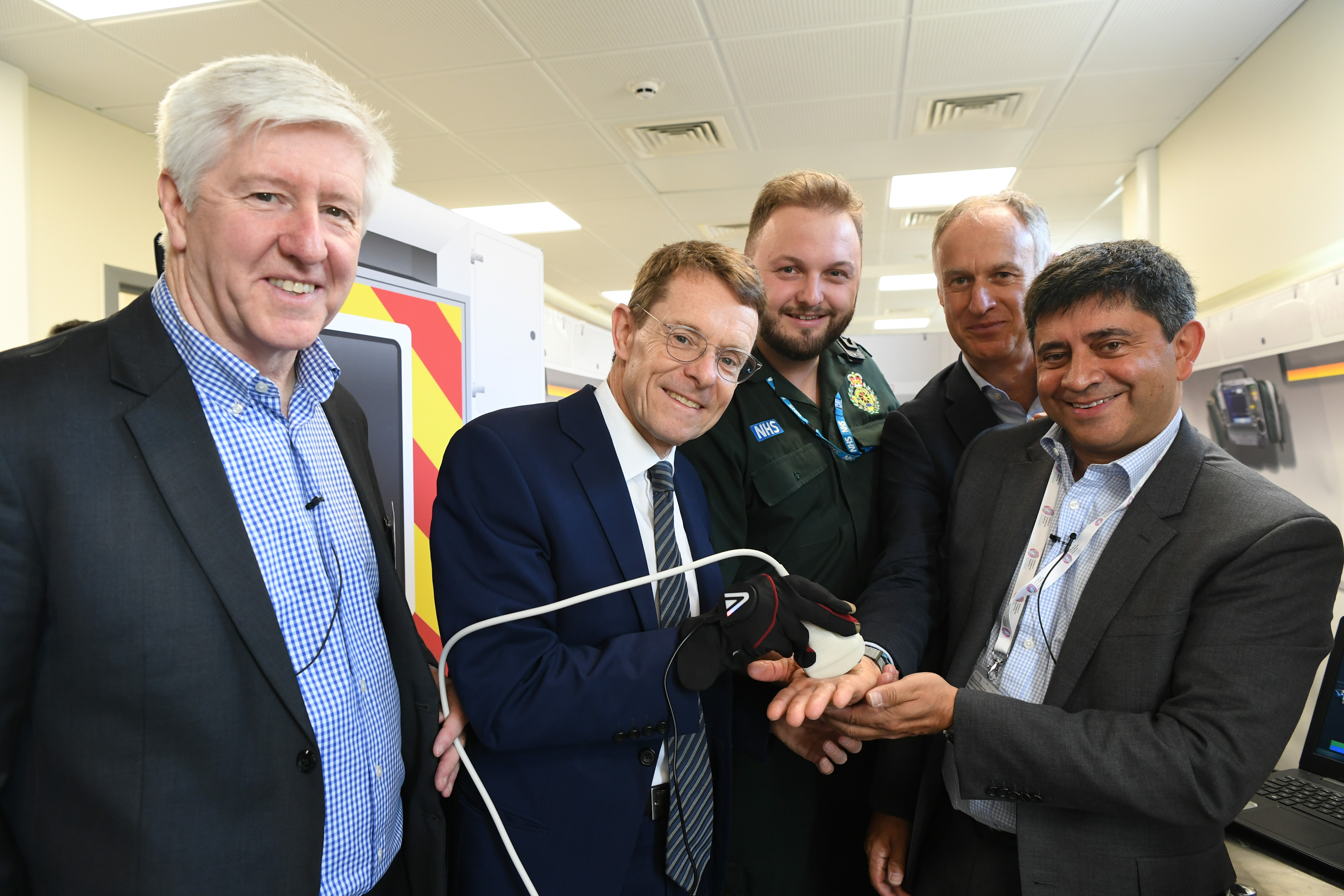 Mayor of the West Midlands, Andy Street (centre) tries out the haptic glove alongside Omkar Chana from WM5G and Fotis Karonis and Jeremy Spencer from BT