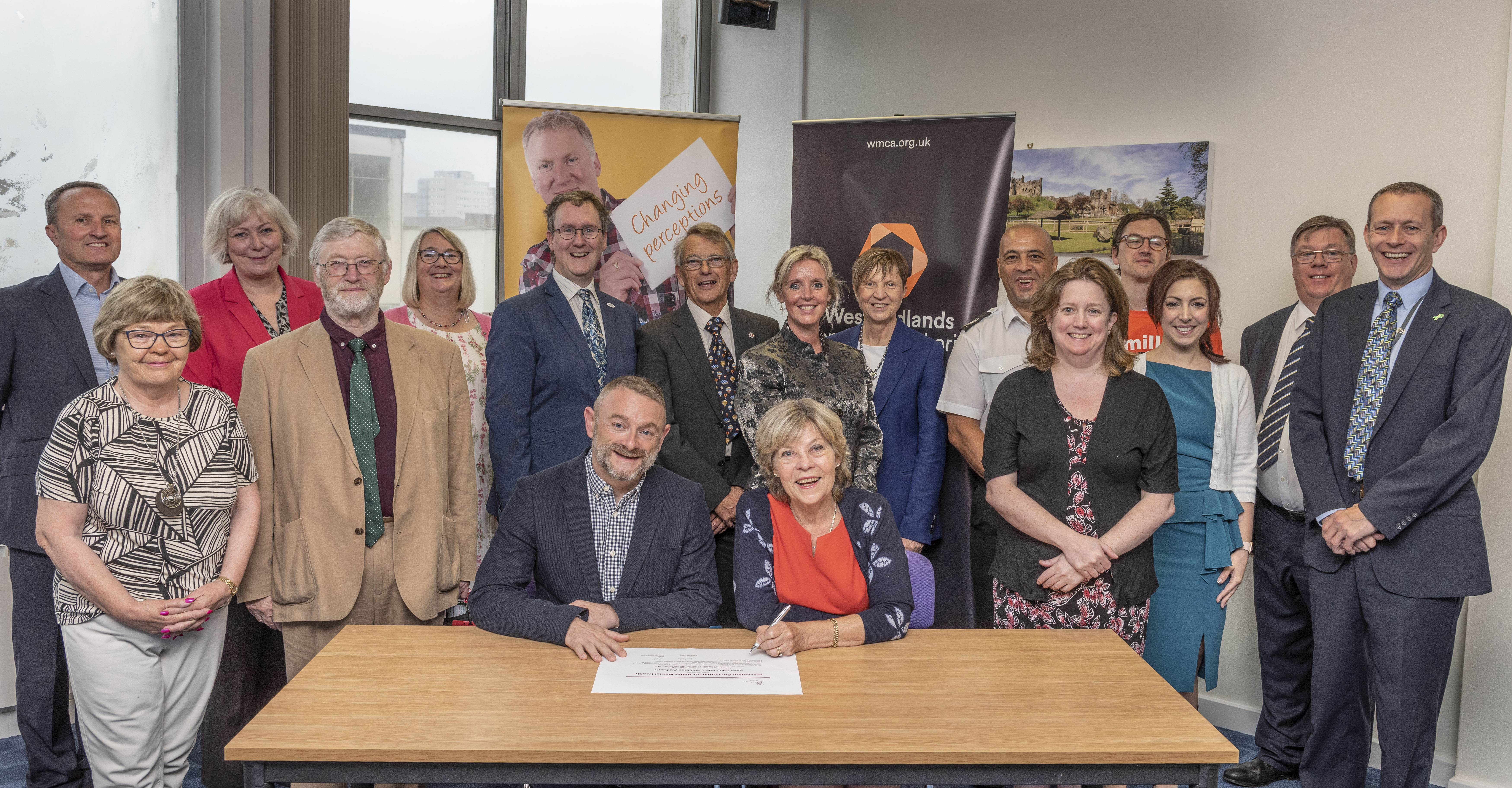 Members of the WMCA’s Wellbeing Board with (front) L-R Paul Sanderson, Health and Wellbeing programme lead for Public Health England in the West Midlands, and Wellbeing Board chair Cllr Izzi Seccombe signing the Prevention Concordat for Better Mental Health
