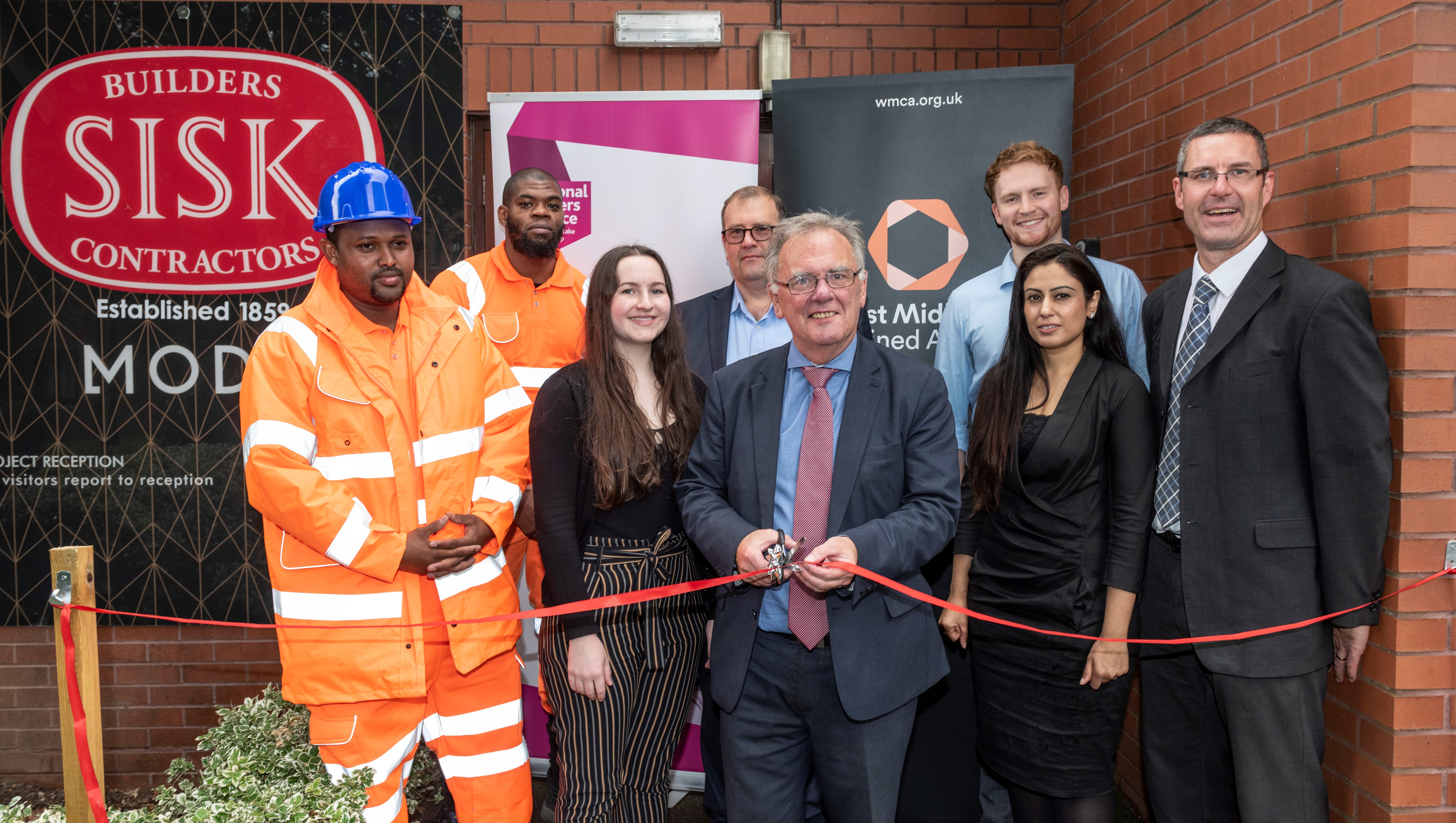 Pictured opening the new construction hub are (L-R) placement trainees Mahad Ali and Nathaniel Robinson, Sisk undergraduate engineer Bethany Brooks, company managing director North & Major Projects Guy Fowler, Cllr Sir Albert Bore (Ladywood), Sisk assistant quantity surveyor Alex Mills, company skills and employment lead Bandhana Karwal and WMCA construction skills project manager Shaun Hall
