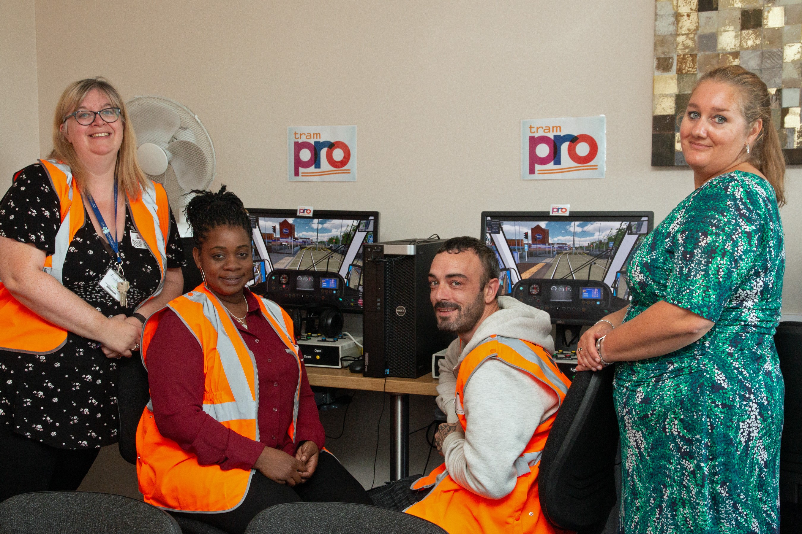 Sector-based Work Academy trainees try out the tram simulator watched by Charlotte Parker from Dudley College (left) and Claire Scrimshire, head of HR and OD at West Midlands Metro