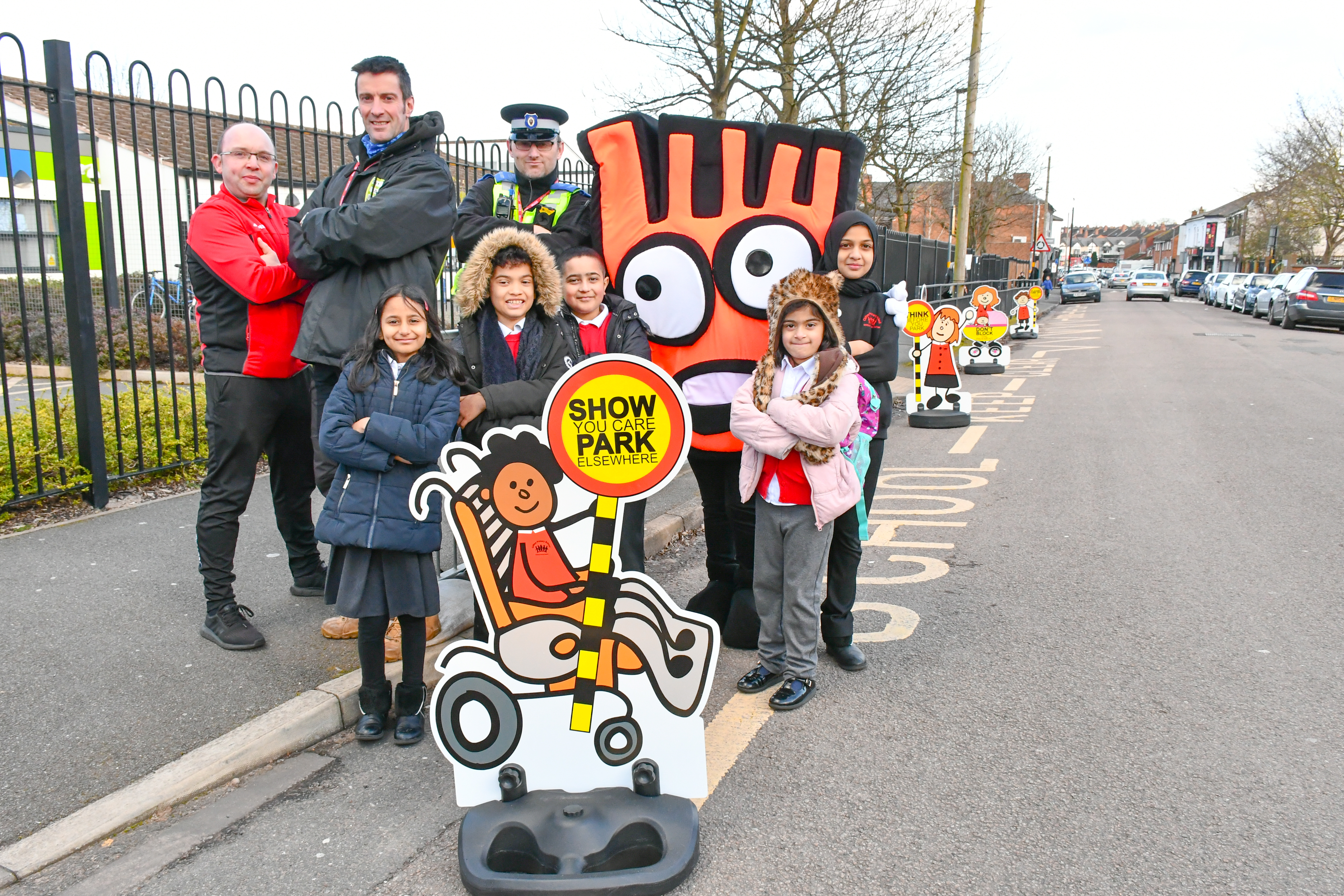 Ed Wicks of Living Streets, Owen Lamprey of Clifton Primary School and PSCO Richard Evans with pupils celebrate the arrival of the new parking buddies