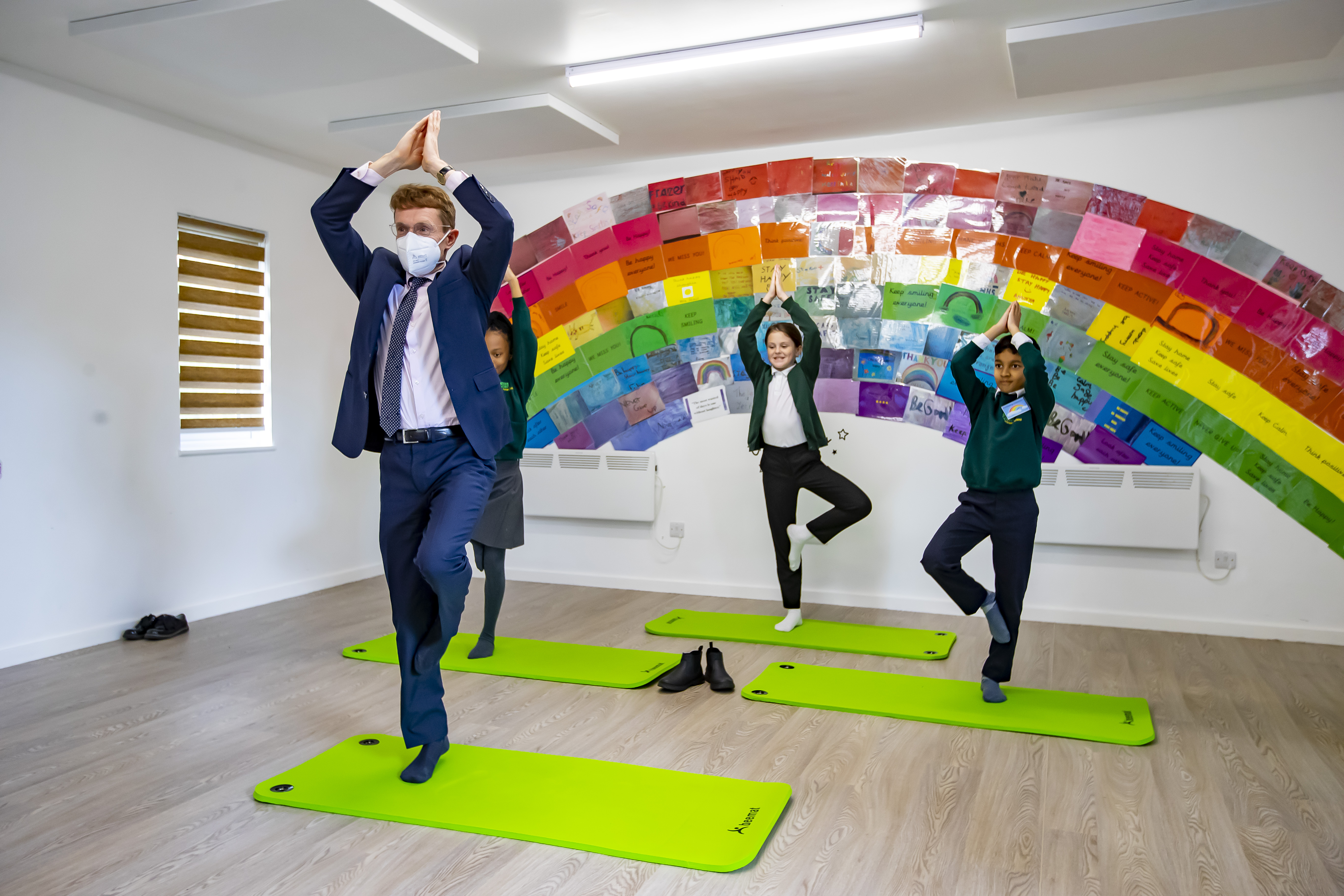 Andy Street, the Mayor of the West Midlands practises yoga with pupils from Acocks Green Primary School (l-r Brooke Hall,  Chloe Thomas, Hamza Shaikh )