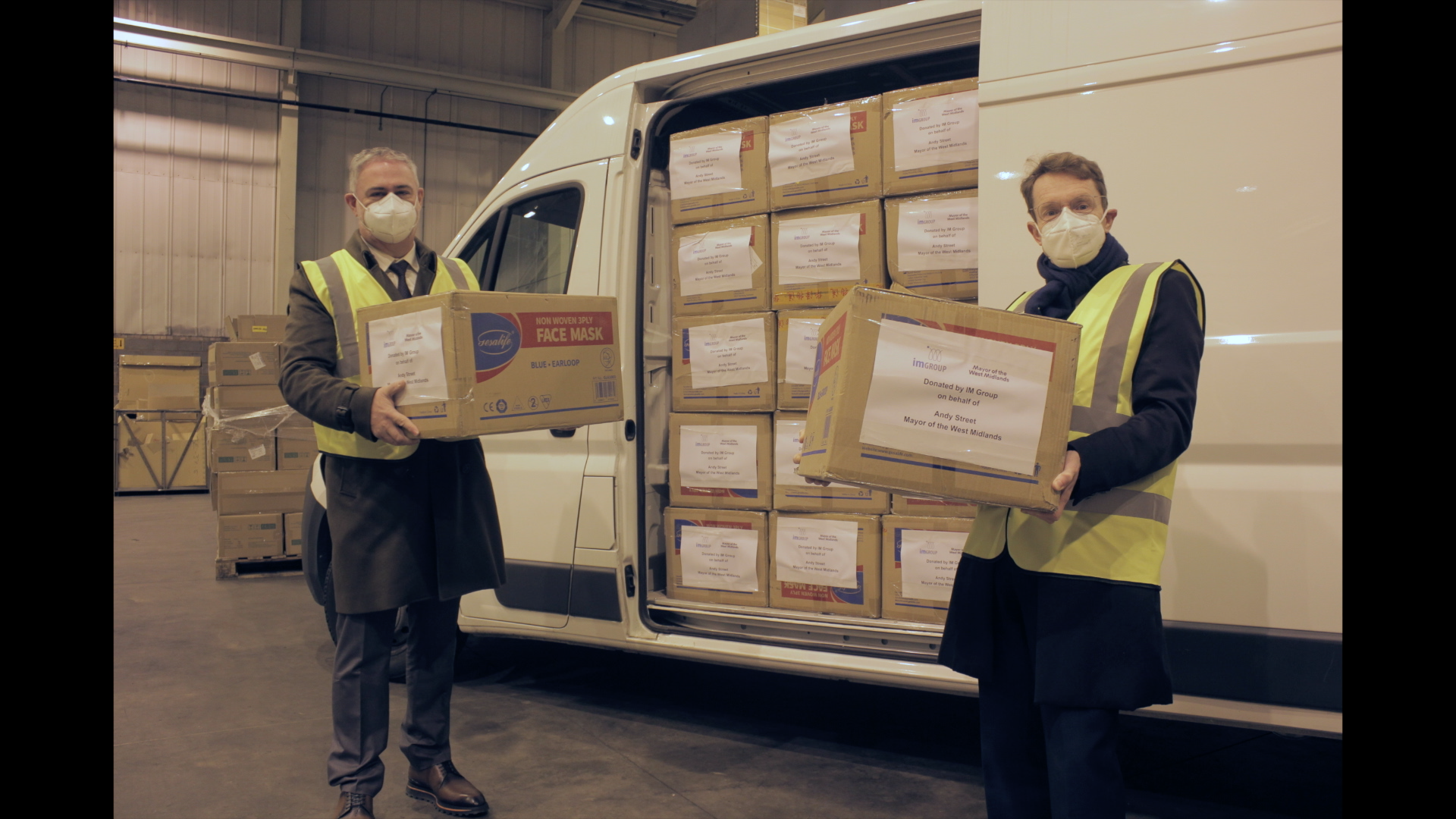 IM Group’s managing director Andrew Edmiston (left) and Mayor of the West Midlands Andy Street get some of the 830,000 items of donated PPE ready for distribution to the region's care and voluntary organisations
