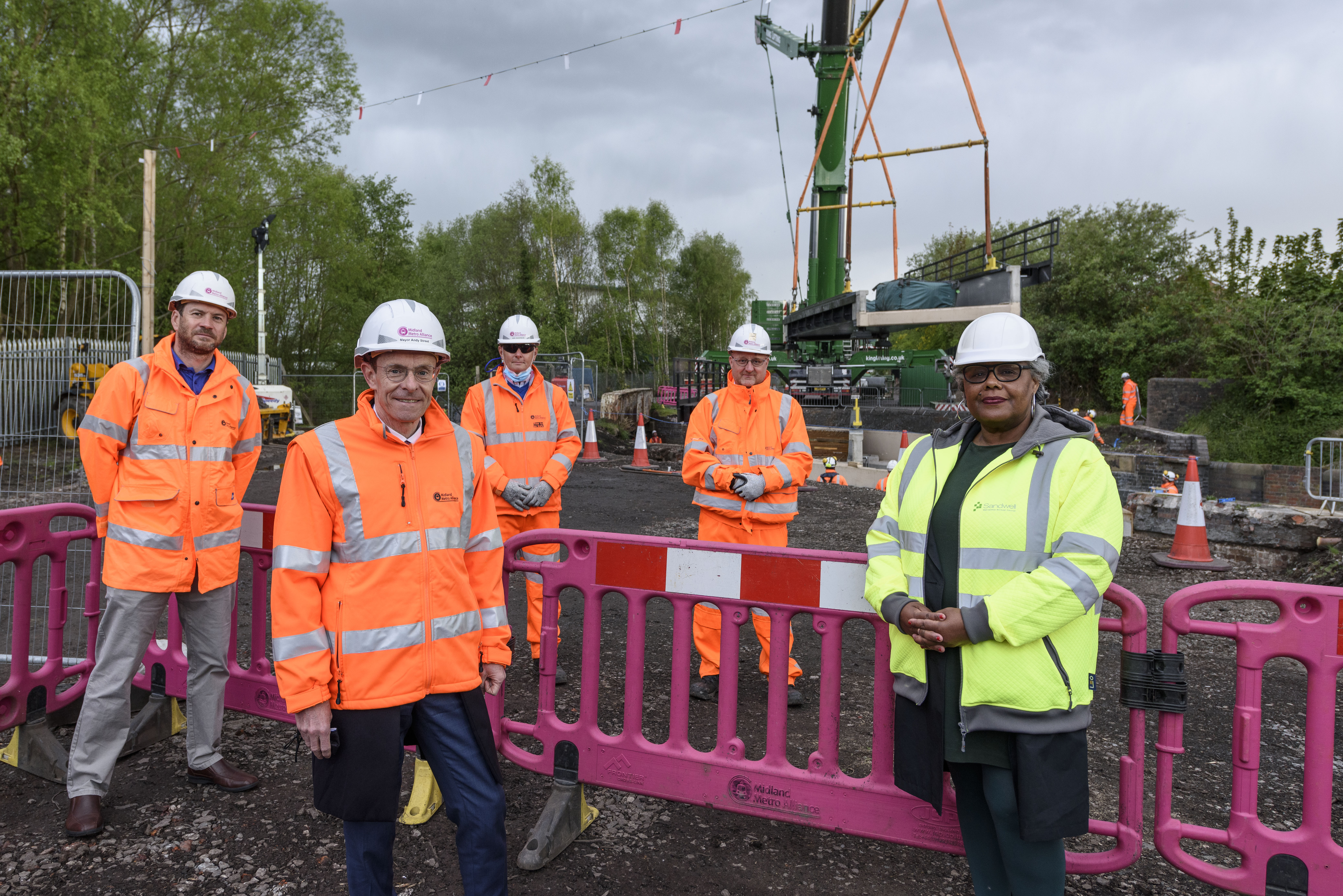 (From left to right) James Dennison (Canal and River Trust); Iain Anderson (Colas Rail UK / Midland Metro Alliance); Ian Collins (Midland Metro Alliance); Andy Street (Mayor of the West Midlands) and Councillor Jackie Taylor (Sandwell Council) celebrate the installation of the first new structure for the Wednesbury to Brierley Hill Metro extension.
