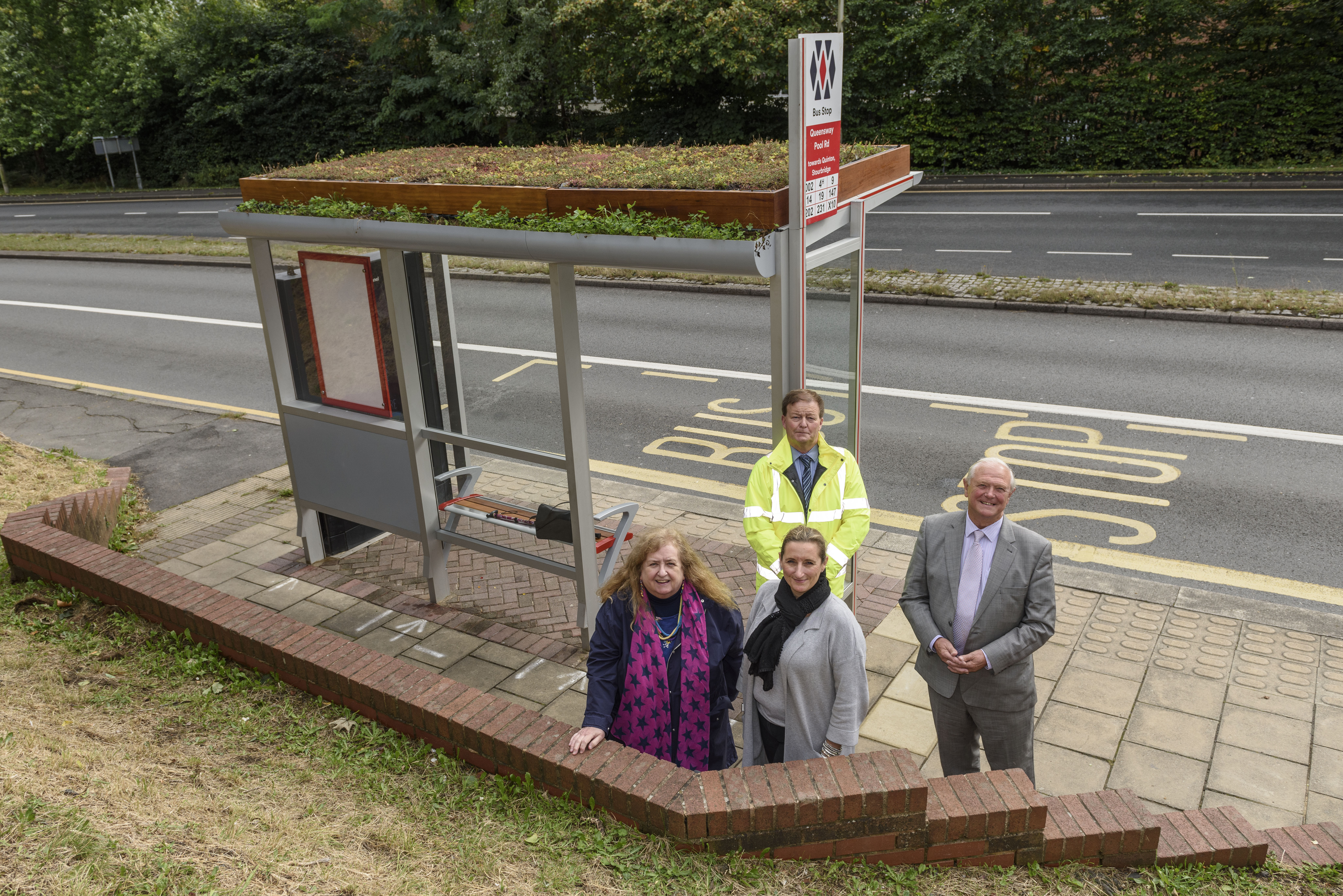 Cllr Kath Hartley (TfWM), Eve O'Connor (Halesowen In Bloom), Cllr Ian Kettle (Dudley Council) and behind Mark Purnell (BSL) welcome the new shelter