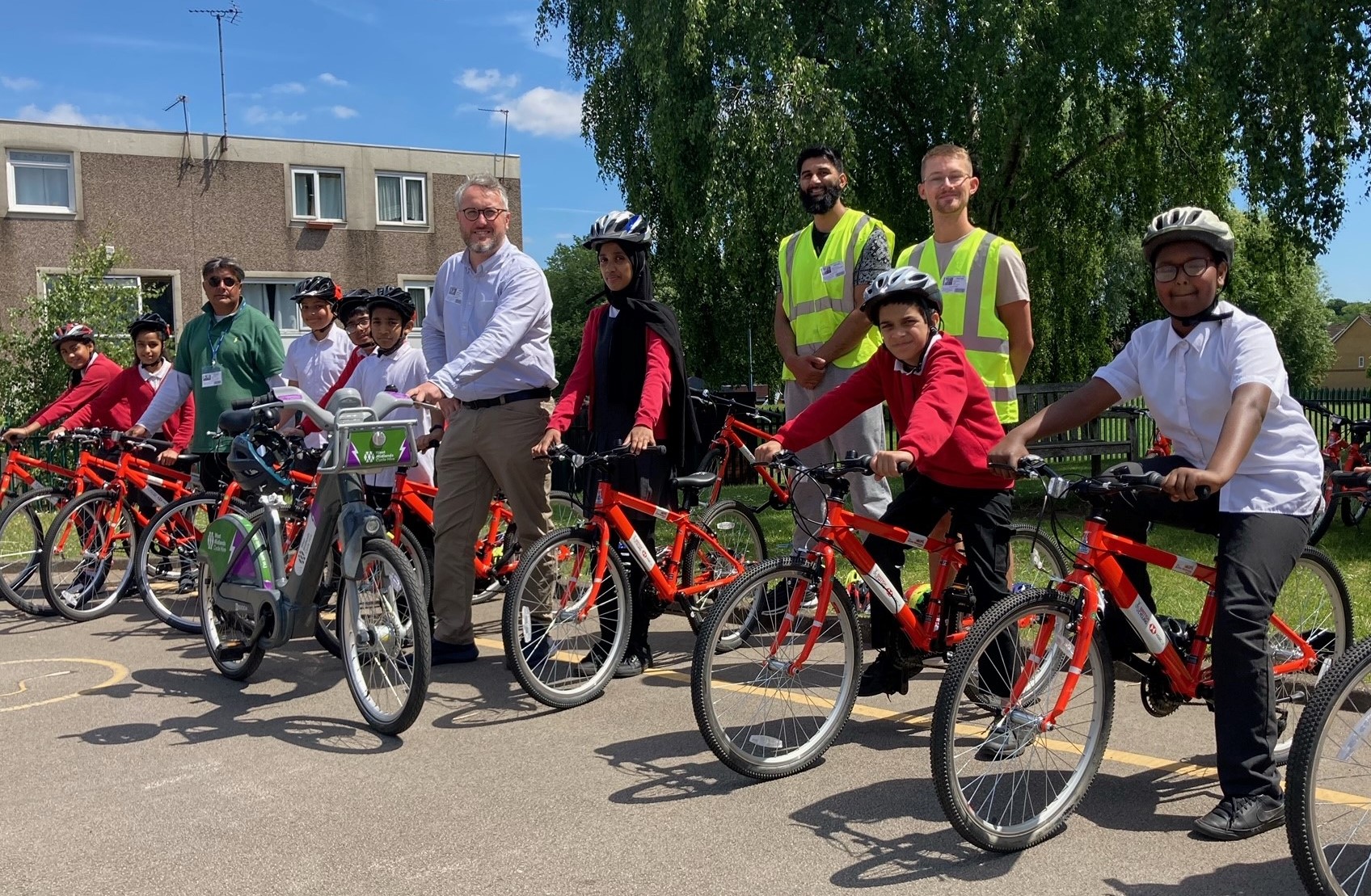 Youngsters from Angelsey Primary School enjoy their cycle skills training with lead instructor Naheem Aziz (green top) and West Midlands Cycling and Walking Commissioner Adam Tranter